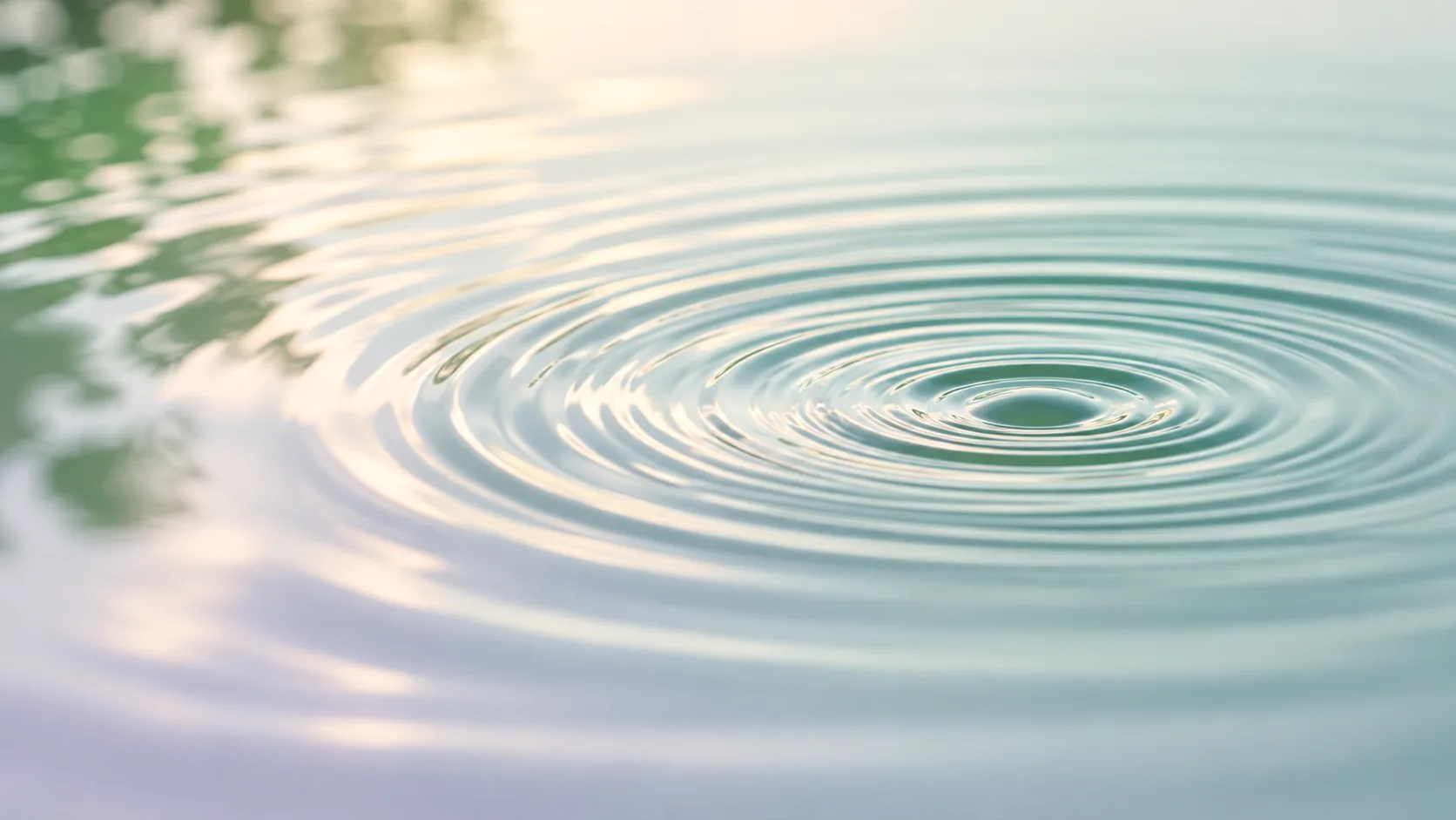 Soft concentric ripples spread across calm water, symbolizing how inflammation begins as a response to a disturbance and gradually resolves as the body returns to balance.